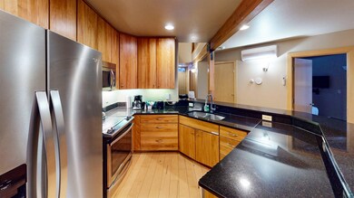 Kitchen featuring sink, a wall mounted air conditi