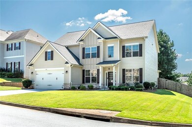Craftsman house featuring board and batten siding, concrete driveway, a garage, and a shingled roof