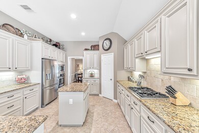 This kitchen is a chefs dream! Just look at how bright it is with all of the beautiful cabinetry and granite workspace.