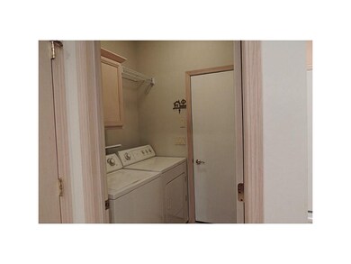 . Laundry room with cabinets and drying rack.