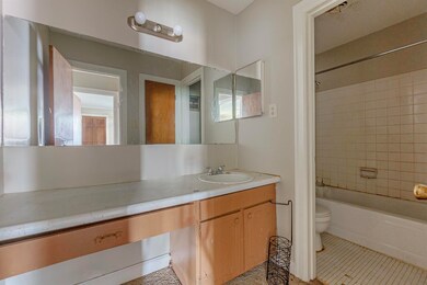Bathroom with vanity, tile patterned floors, and  shower combination