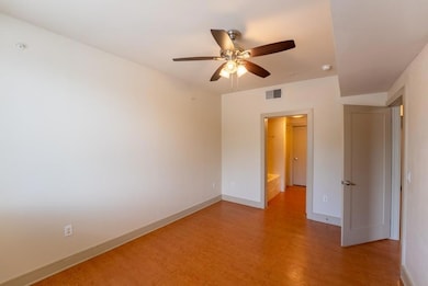 Unfurnished room featuring visible vents, baseboa