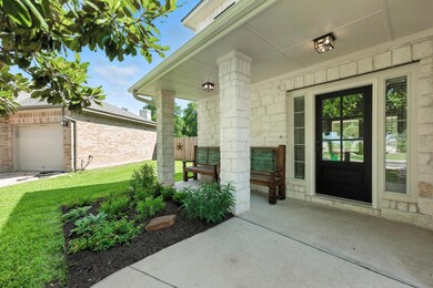 View of exterior entry featuring a lawn, a garage