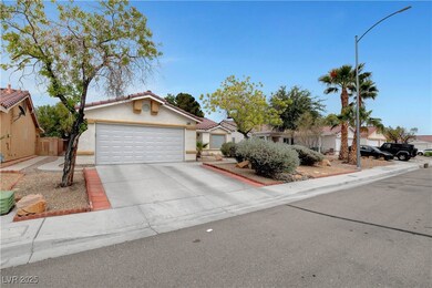 View of front of house with stucco siding and driv