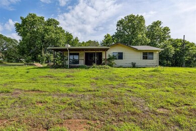 Rear view of property featuring a yard