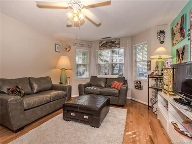 Cozy, but light filled living room has room for  e