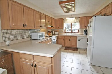 Spacious kitchen with abundant maple cabinetry and