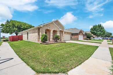 Ranch-style home featuring a front lawn and a gara