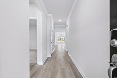 Hallway with light hardwood / wood-style floors an