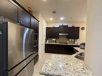 Kitchen with stainless steel appliances, backspla