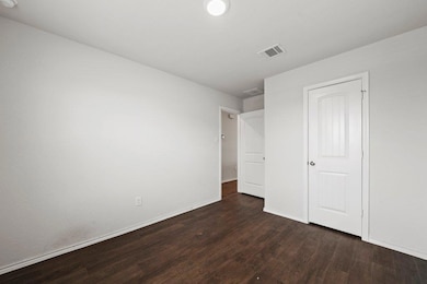 Unfurnished bedroom with dark wood finished floor
