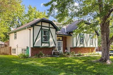 Tudor house with a shingled roof and brick siding