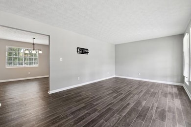Spare room featuring dark wood finished floors, a 