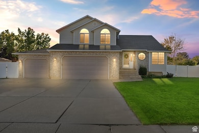 Traditional-style home featuring brick siding, driveway, an attached garage, and roof with shingles