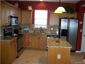 Gorgeous kitchen with center island and slab grani