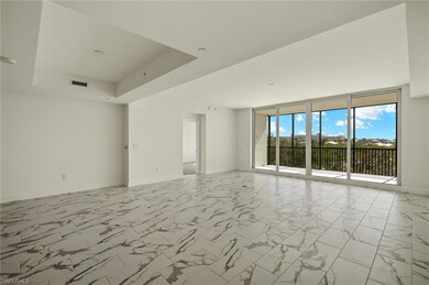 Spacious great room with large windows and elegant neutral palette.