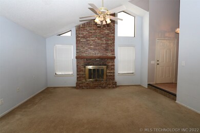 Living with vaulted ceiling and wood-burning firep