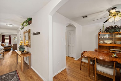Dining room featuring baseboards, arched walkways