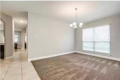Unfurnished room with baseboards, tile patterned f