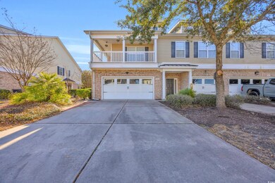 View of front of property with a garage and a balc