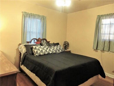 First floor main bedroom with hardwood floors and 