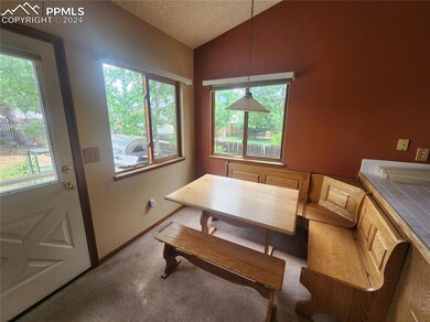 Dining area featuring carpet floors, a textured ce