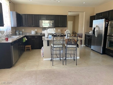 Kitchen with stainless steel appliances, a sink, a