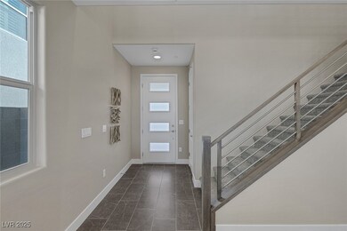 Foyer featuring baseboards, stairs, and dark marbl