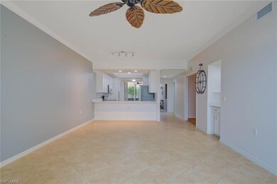 Unfurnished living room with a ceiling fan, crown molding, rail lighting, and light tile patterned floors