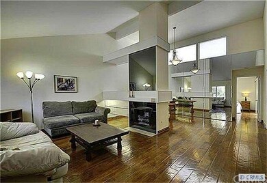 Formal living room with vaulted ceiling and mantle
