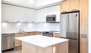 Kitchen with decorative backsplash, light countert