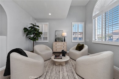 LIVING ROOM WITH HIGH CEILINGS, CUSTOM WOOD SHUTTERS. LOTS OF WARM NATURAL LIGHT COMING THROUGH THE WINDOWS.