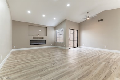Living room featuring LED glass covered fireplace,