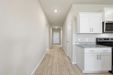 Hall featuring recessed lighting and wood tiled floors