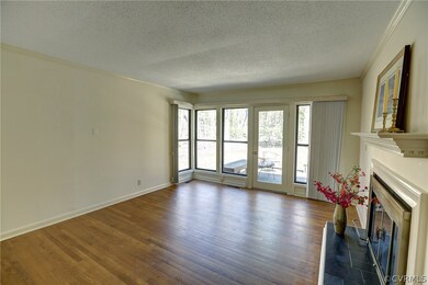Family room with hardwood floors and crown mouldin