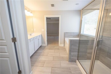 Full bathroom with a garden tub, vanity, visible v