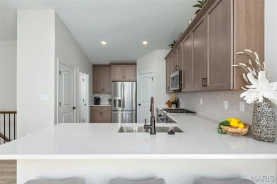 Kitchen with a kitchen bar, kitchen peninsula, and stainless steel appliances