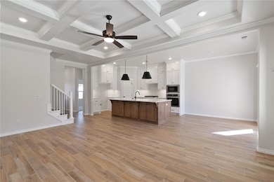 Kitchen with white cabinetry, ornamental molding, 