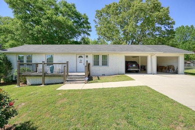 Single story home featuring a front lawn, concrete