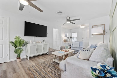 Living area featuring visible vents, baseboards, w