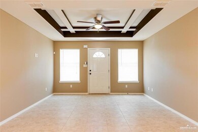 Entrance foyer featuring a raised ceiling, ceiling fan, baseboards, and visible vents