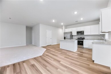 Open kitchen to gathering room with modern white c