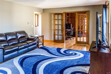 Atrium doors in living room open into a large offi