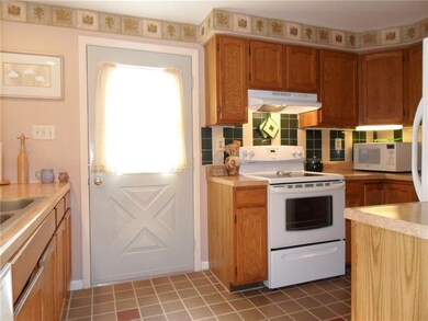 Galley Style Kitchen with Tile Floor and Backsplas