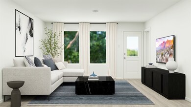 Living area with light wood-style flooring and baseboards