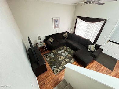 Living area featuring wood finished floors and a ceiling fan