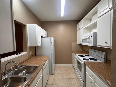 Kitchen with decorative backsplash, white applian