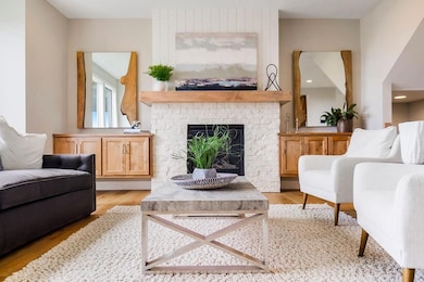 Living area with light wood finished floors and a fireplace