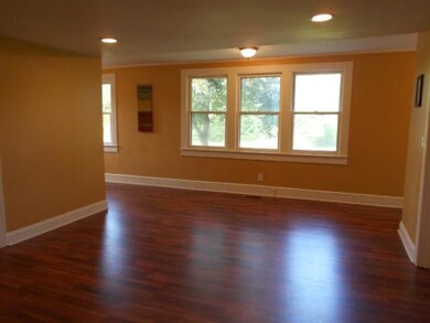 Living room with fresh paint and STUNNING laminate-wood flooring! Windows offer breathtaking views on every side!