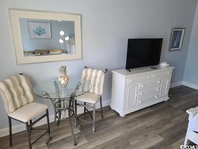 Dining room featuring dark wood-type flooring